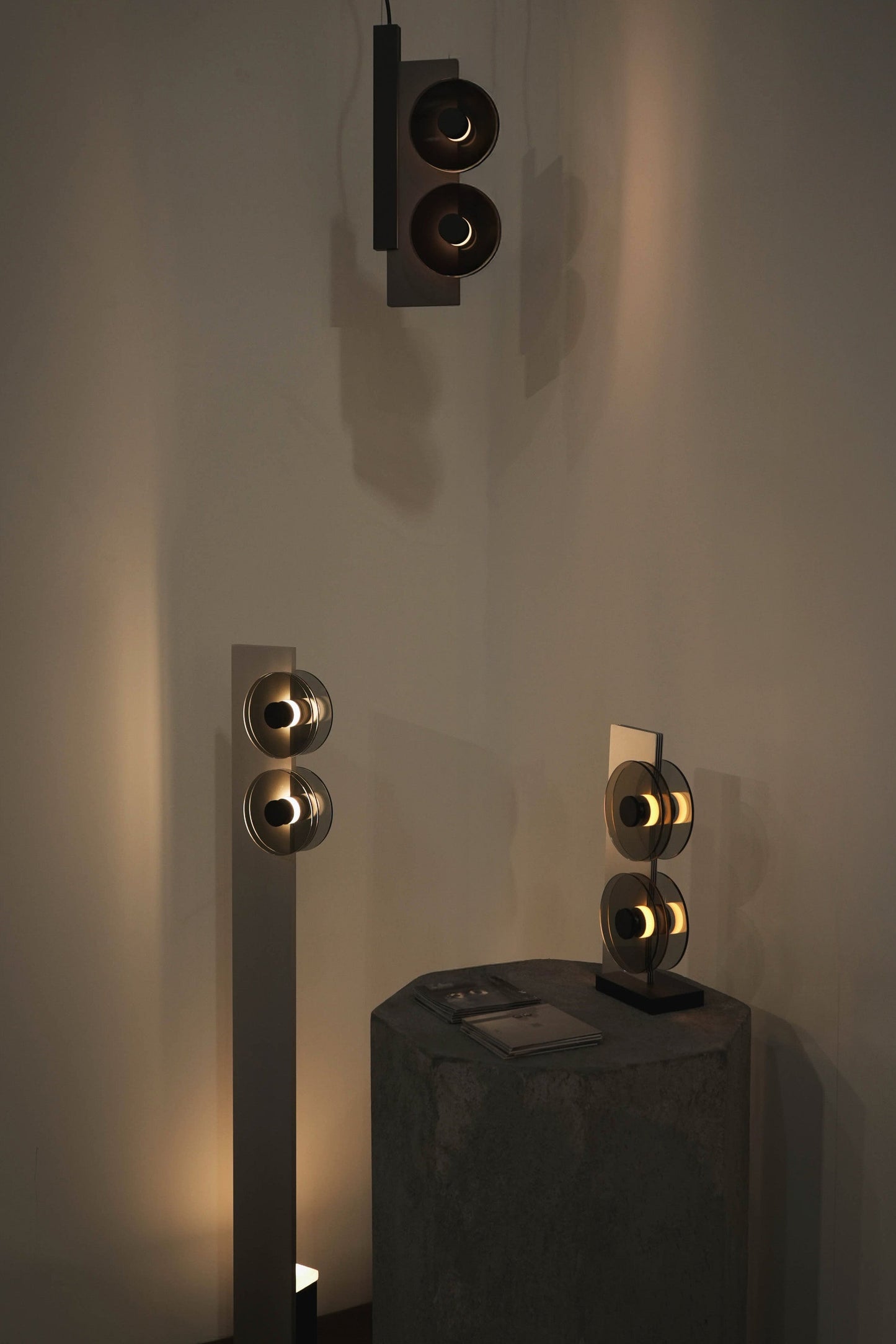 Modern wall-mounted light fixtures on a neutral wall.