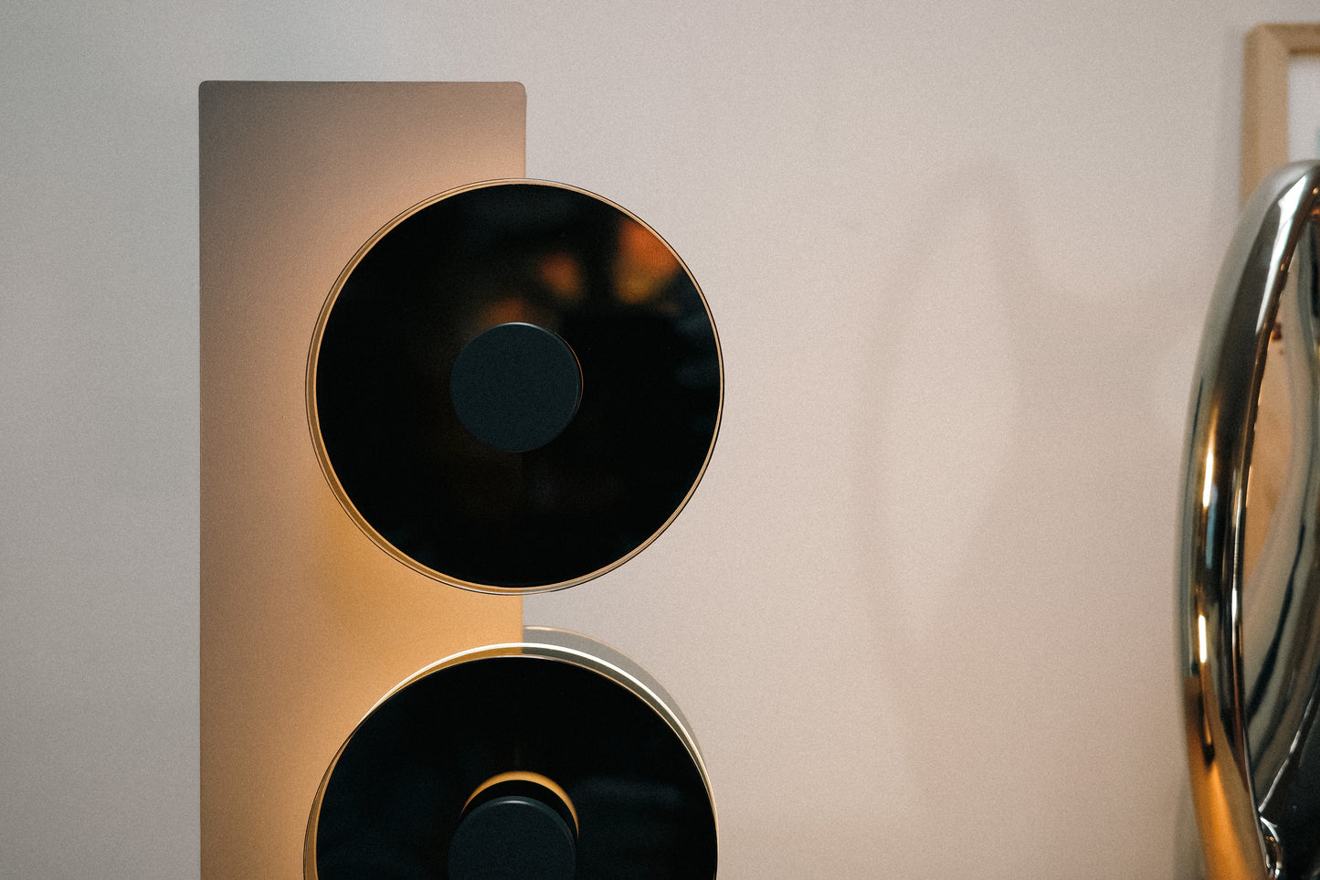Close-up of a modern speaker design with metallic and black elements.