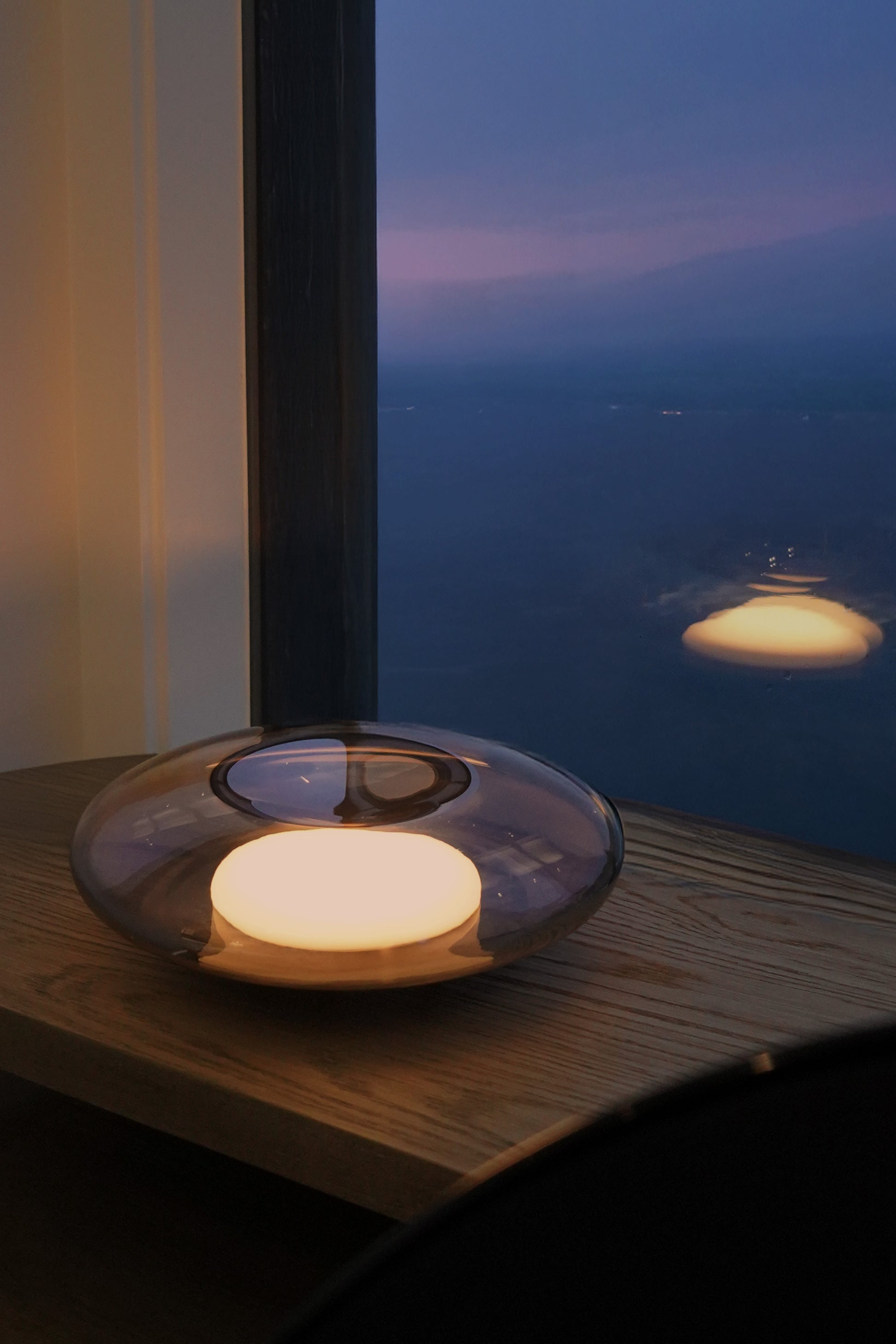 Solar lamp on a table with a scenic view of the sky in the background