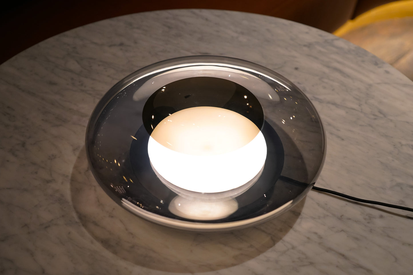 Round light fixture on a marble surface