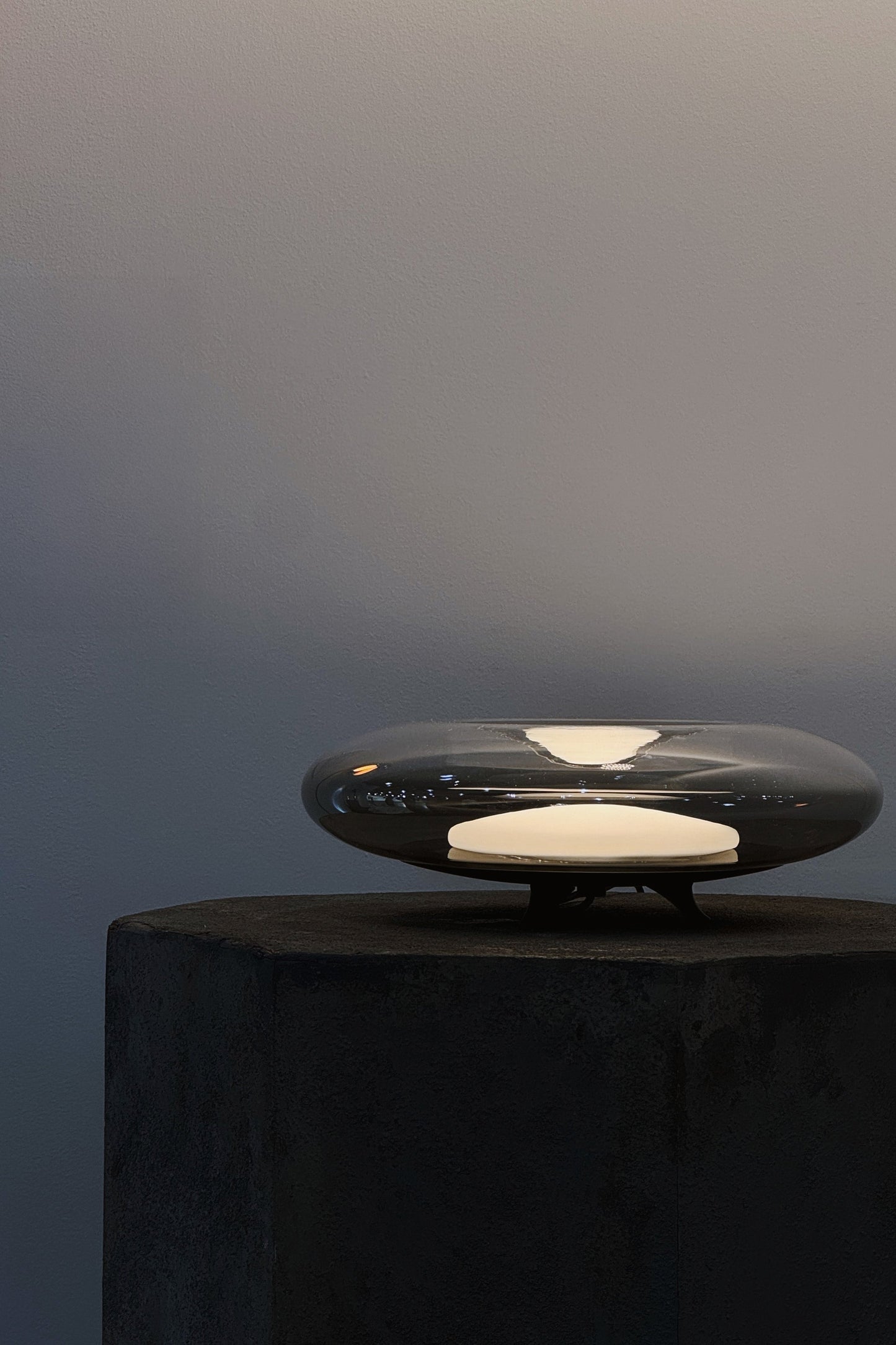 Modern electronic device on a dark surface with a gradient gray background