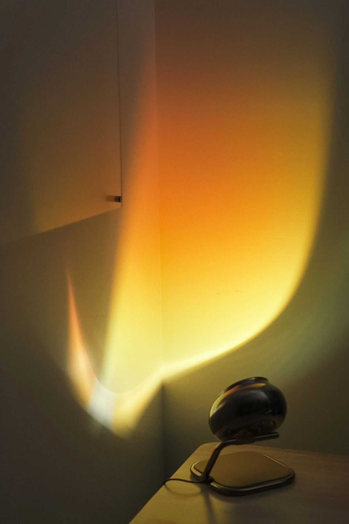 Small lamp casting a warm glow on a wall
