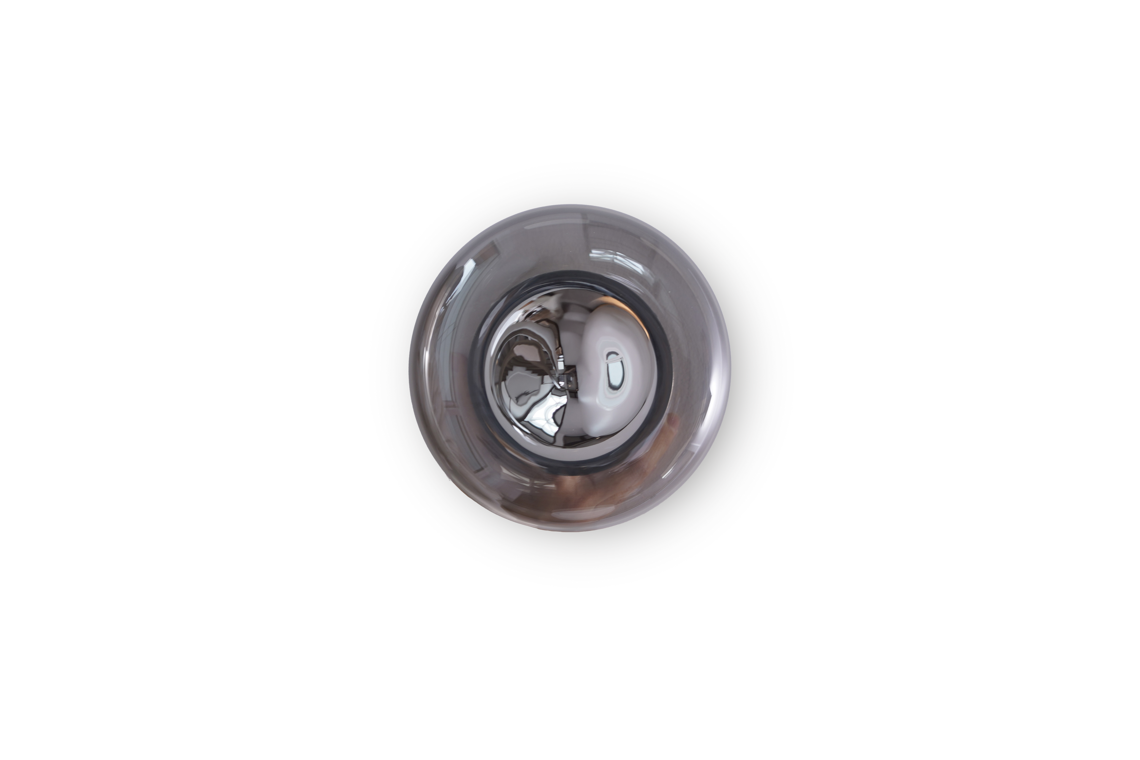 Metallic sink drain plug on a white background
