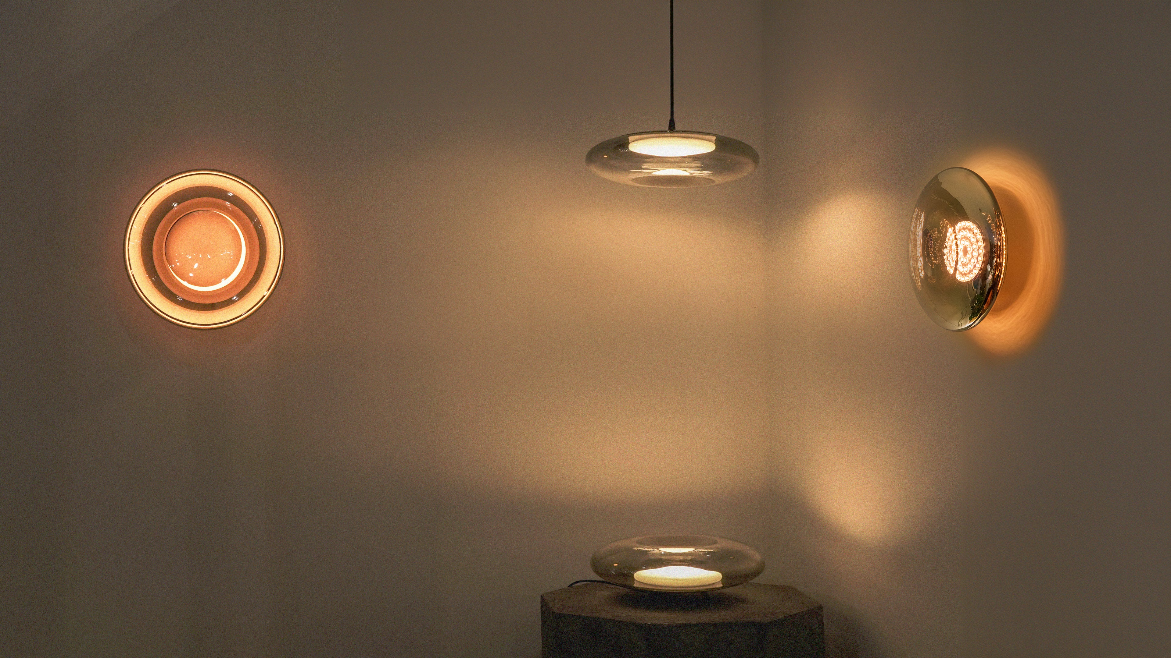 Modern pendant light fixture with circular design on a neutral background