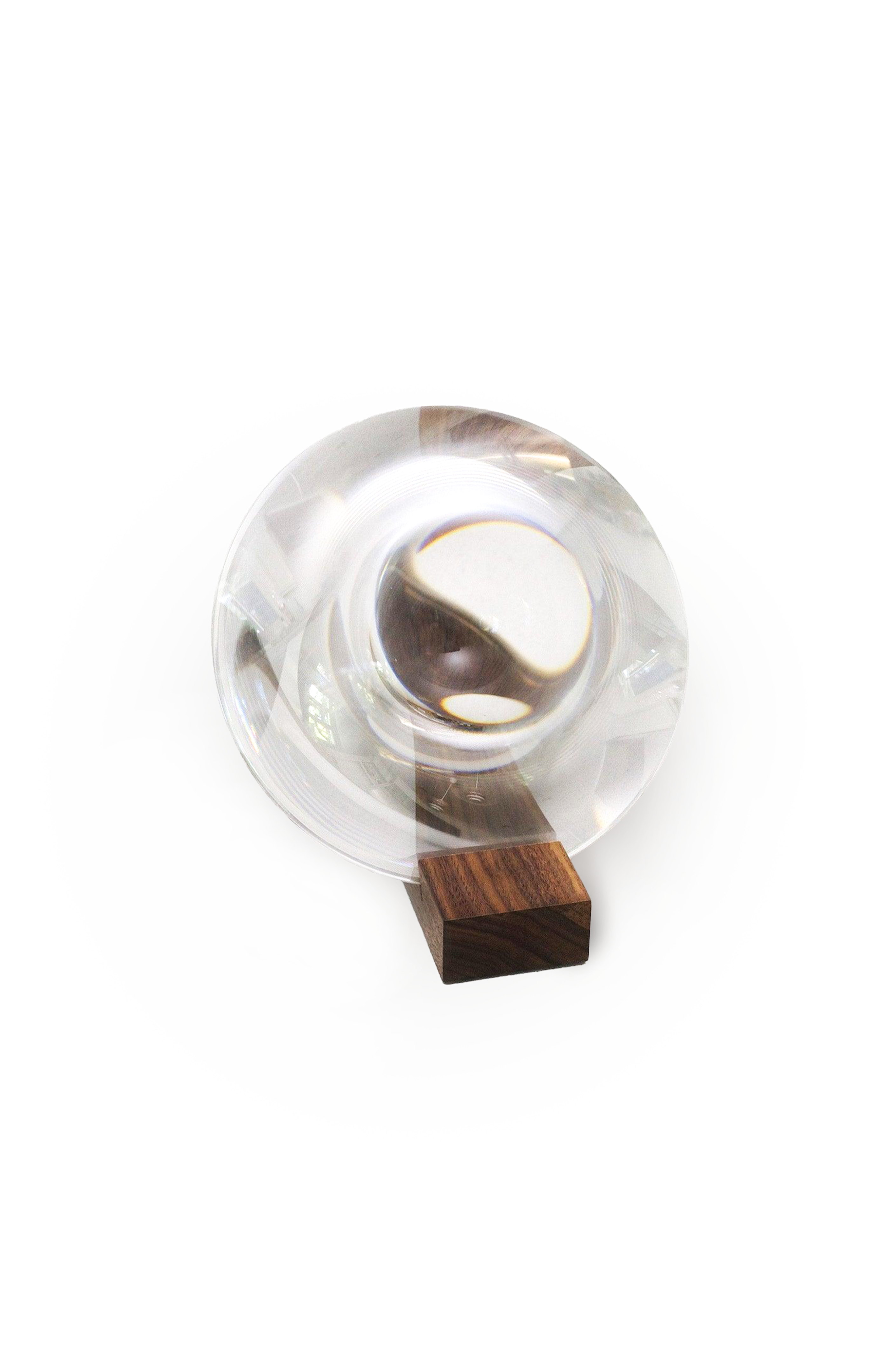 Clear magnifying glass with wooden base on a white background