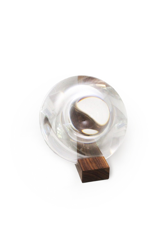 Clear magnifying glass with wooden base on a white background