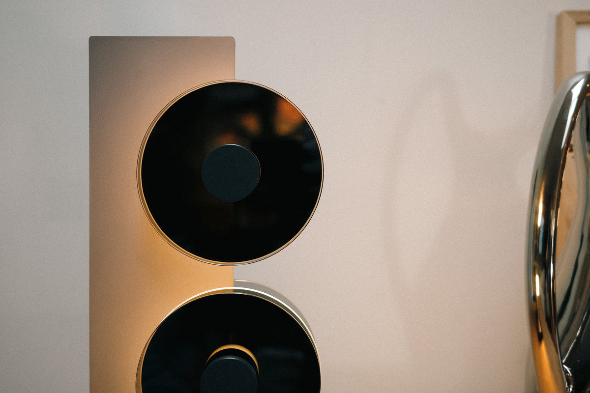 Close-up of a modern speaker design with metallic and black elements.