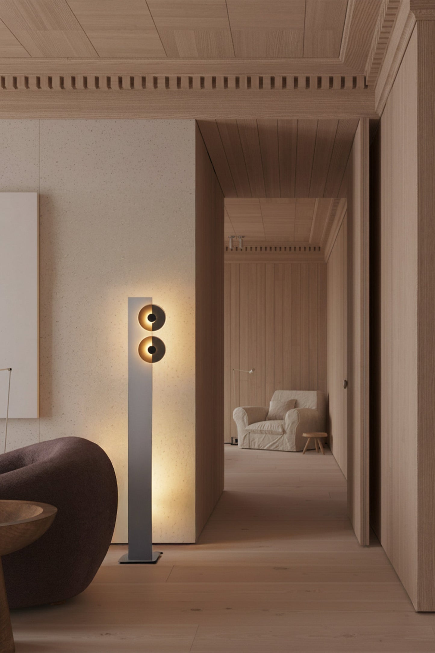 Modern interior with a tall floor lamp casting light into a room.