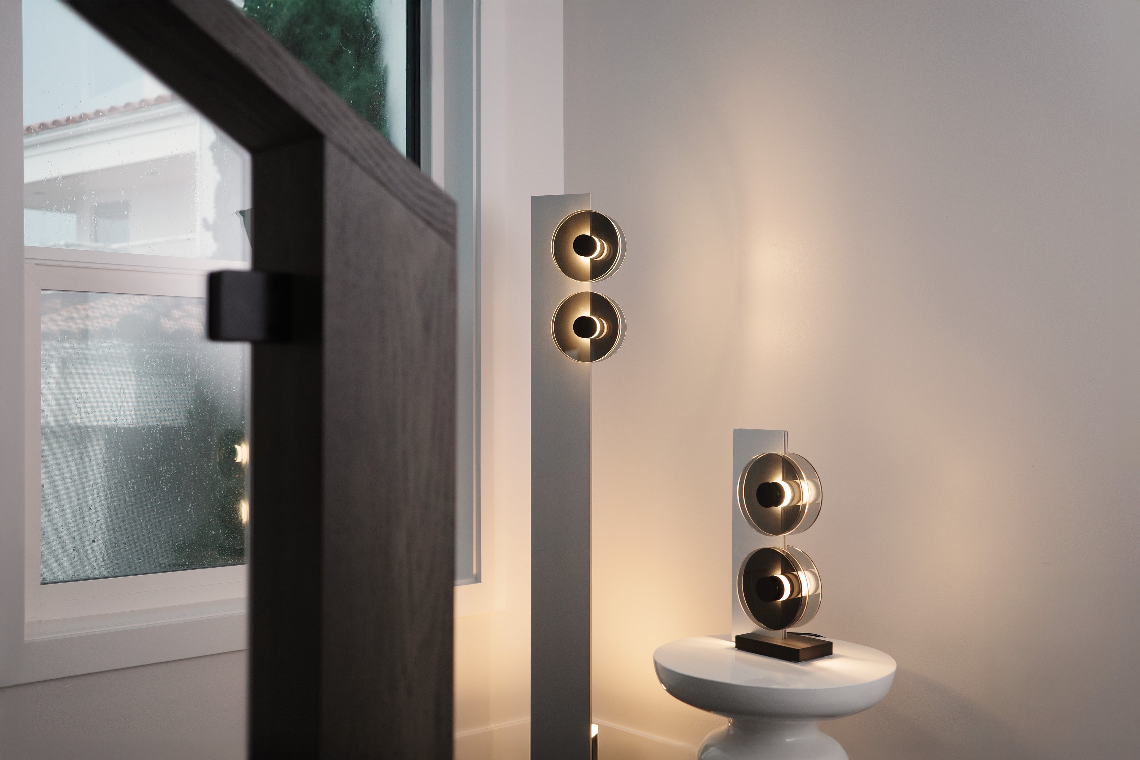 Modern wall-mounted speakers on a neutral background
