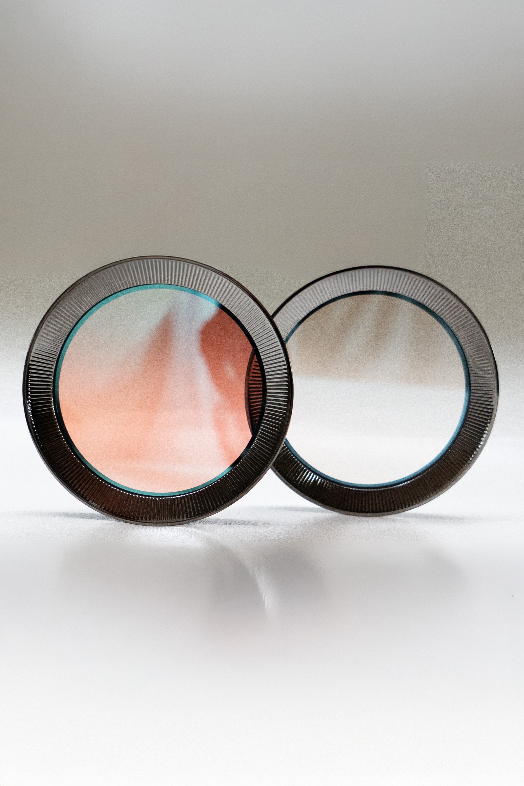 Two circular filters on a light gray background