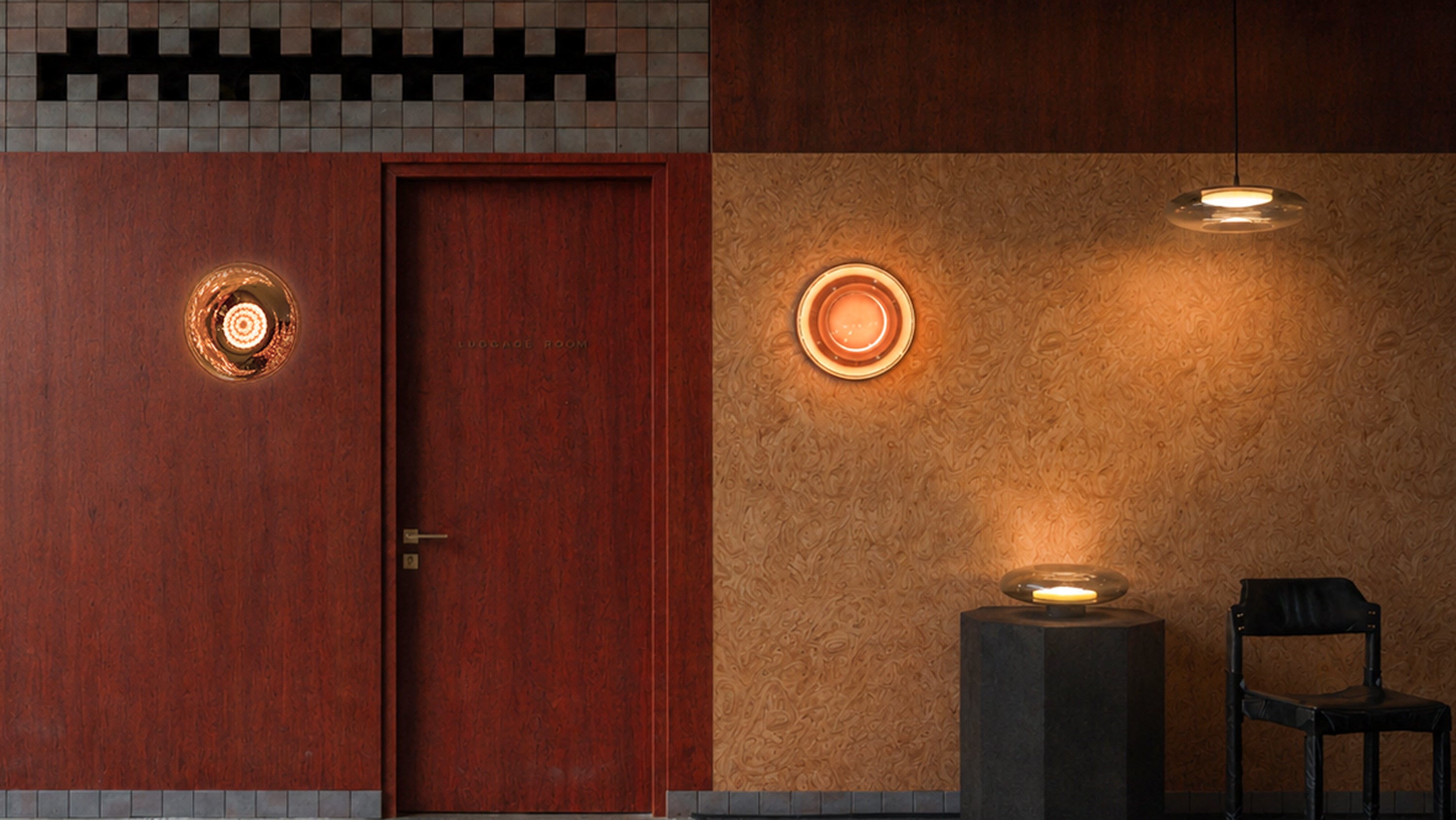 Room interior with a red door, wall lights, and a small table.